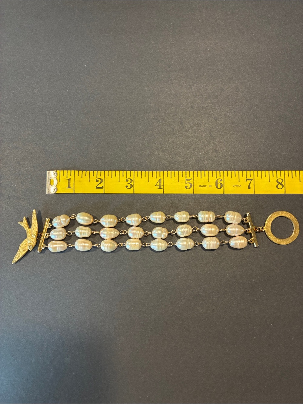Gold and Pearl Multi-Strand Bracelet with Swallow closure